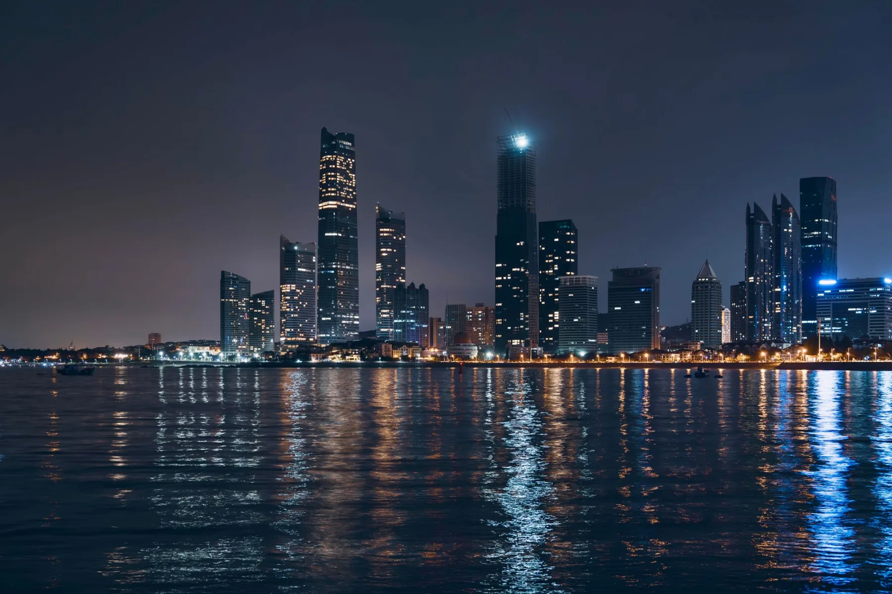 The Abu Dhabi city skyline lit at night across the water