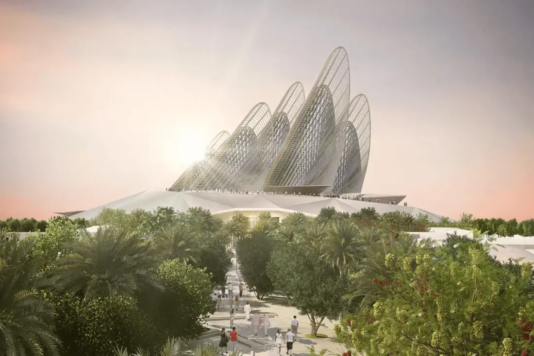 The steel wings of Zayed National Museum rising above landscaped grounds at dusk